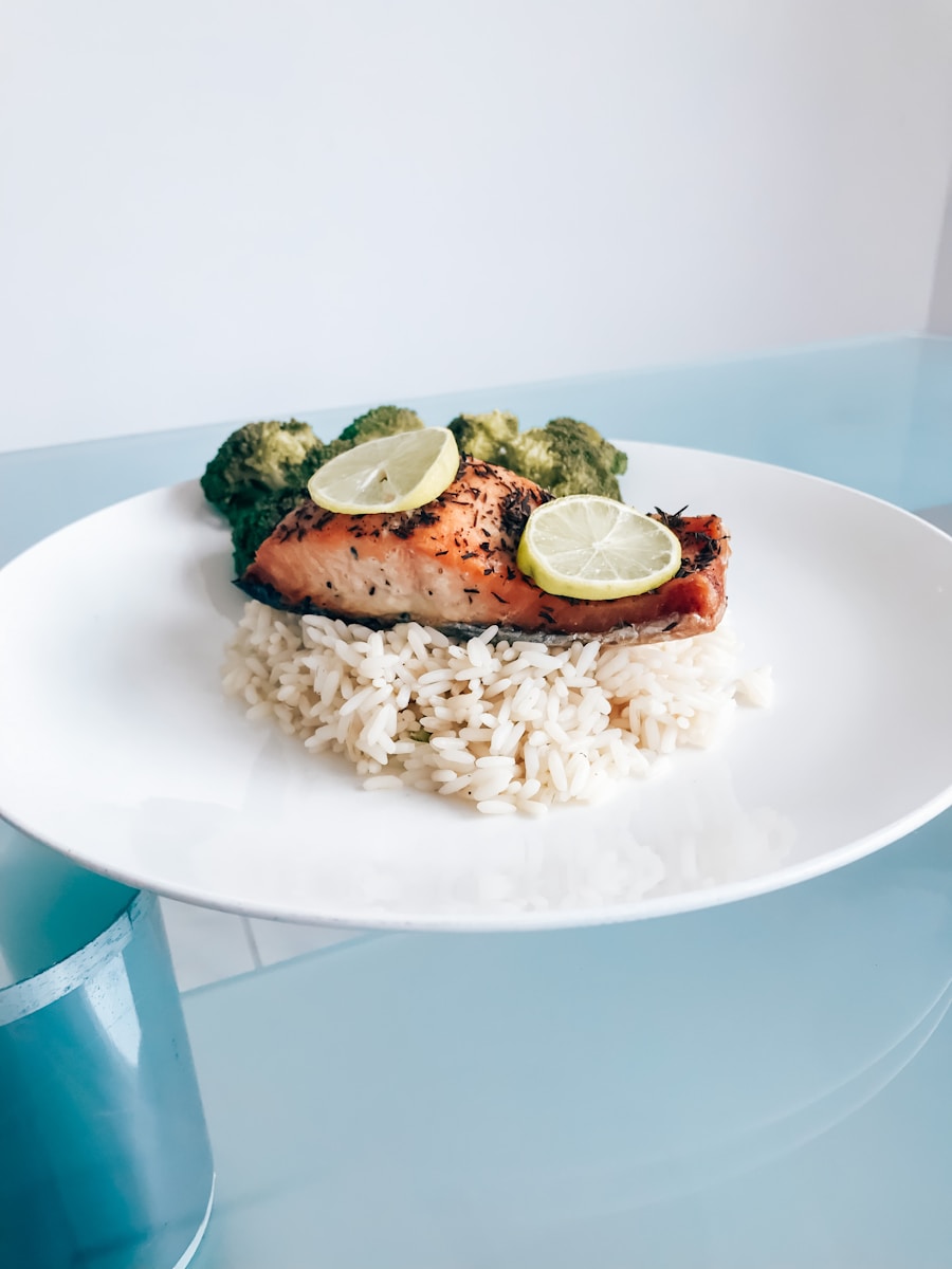 a white plate topped with rice and a piece of salmon